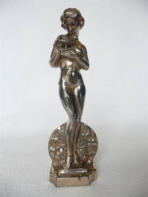 Lot 1489 - An Art Deco White Metal Figural Table Strike Lighter, modelled as a nude young woman holding a...