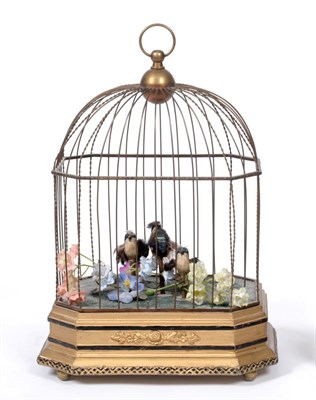 Lot 3131 - A Late Triple Singing Birds-In-Cage, By Karl Griesbaum, with multi-coloured plumage, later...