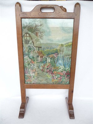 Lot 1503 - A Robert "Mouseman" Thompson Oak Firescreen, pierced hand hole, the frame inset with a cottage...