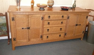 Lot 1512 - An Alan Grainger Acorn Industries Oak Sideboard, the central section fitted with four...