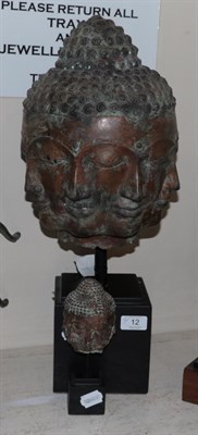 Lot 12 - A bronze multiple face Buddha head and a similar smaller head (2)