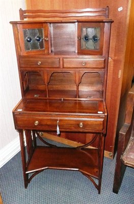 Lot 1532 - An Arts & Crafts Mahogany Lady's Writing Desk Cabinet, with two glazed doors above two small...