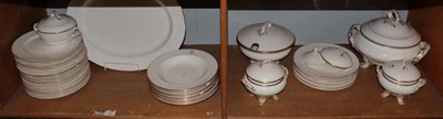 Lot 21 - A group of dinner wares bearing various crests and with gilt borders including tureens; dinner...