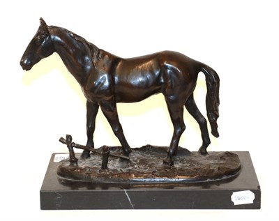 Lot 57 - A bronze model of a horse on a black marble plinth