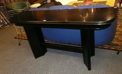 Lot 1538 - An Art Deco Ebonised Folding Console/Dining Table, on twin pedestal base, joined by a...