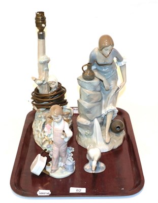 Lot 82 - A Lladro figural table lamp, Lladro figure of a child, Lladro figure of a swan, Nao figure of a...
