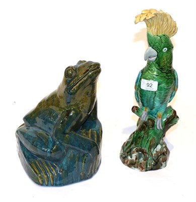 Lot 92 - A Mintons majolica model of a green cockatoo and a green pottery frog