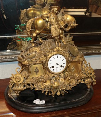 Lot 113 - A French gilt metal striking mantel clock, the elaborate case surmounted by a gentleman leaning...