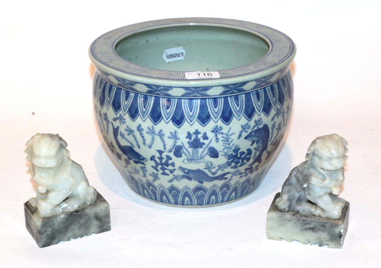 Lot 116 - A Chinese blue and white fish bowl and a pair of carved green stone temple lions