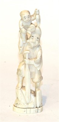 Lot 129 - A Japanese Meiji period ivory Okimono of a man and boy, signed