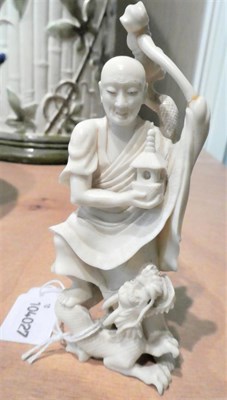 Lot 142 - An early 20th century carved ivory Japanese okimono, figure with a dragon, 14cm; together with...