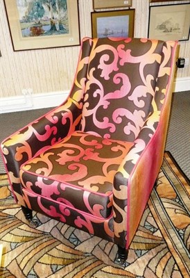 Lot 1548 - A Delcor Duke Model Easy Chair, upholstered in pink and black with a scrolling pattern, the...