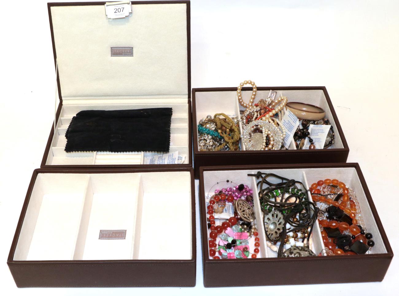 Lot 207 - A collection of silver and costume jewellery including brooches, beads, bangles etc, in a stackable