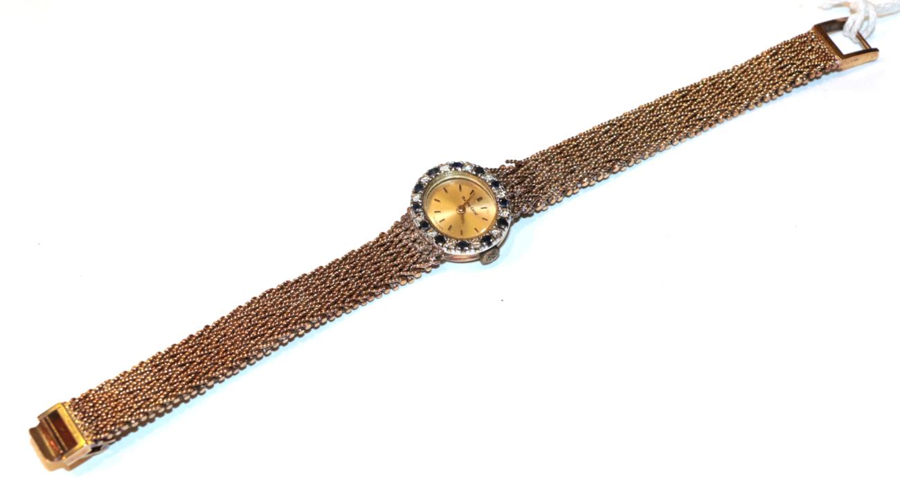 Lot 232 - A 9 carat Bueche Girod wristwatch, diamond and sapphire bezel