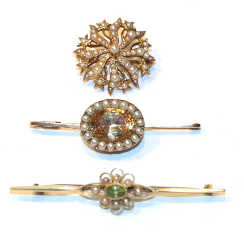 Lot 239 - A seed pearl star brooch, stamped '15CT', length 3.6cm; a peridot and seed pearl bar brooch,...