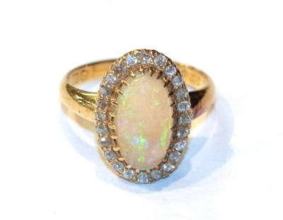 Lot 243 - An 18 carat gold opal and diamond cluster ring, finger size K1/2