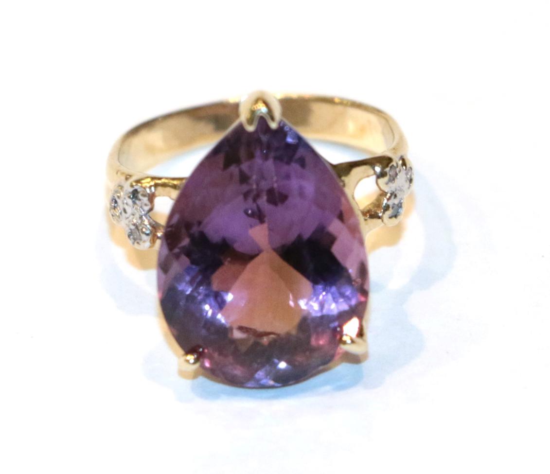 Lot 250 - A pear shaped amethyst solitaire ring with diamond set shoulders, finger size I1/2