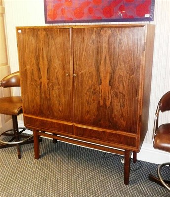 Lot 1556 - A Danish Rosewood Drinks Cabinet, the two section fitted interior part fitted with mirrored and...