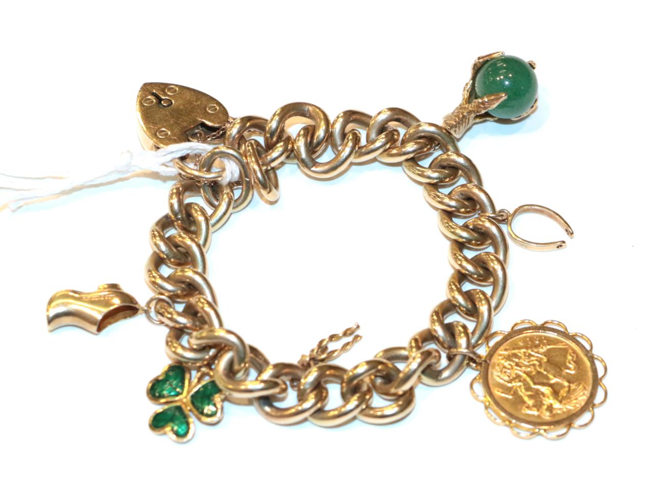 Lot 258 - A curb and lock bracelet, stamped '9' and '.375', hung with four charms including a 1910 half...