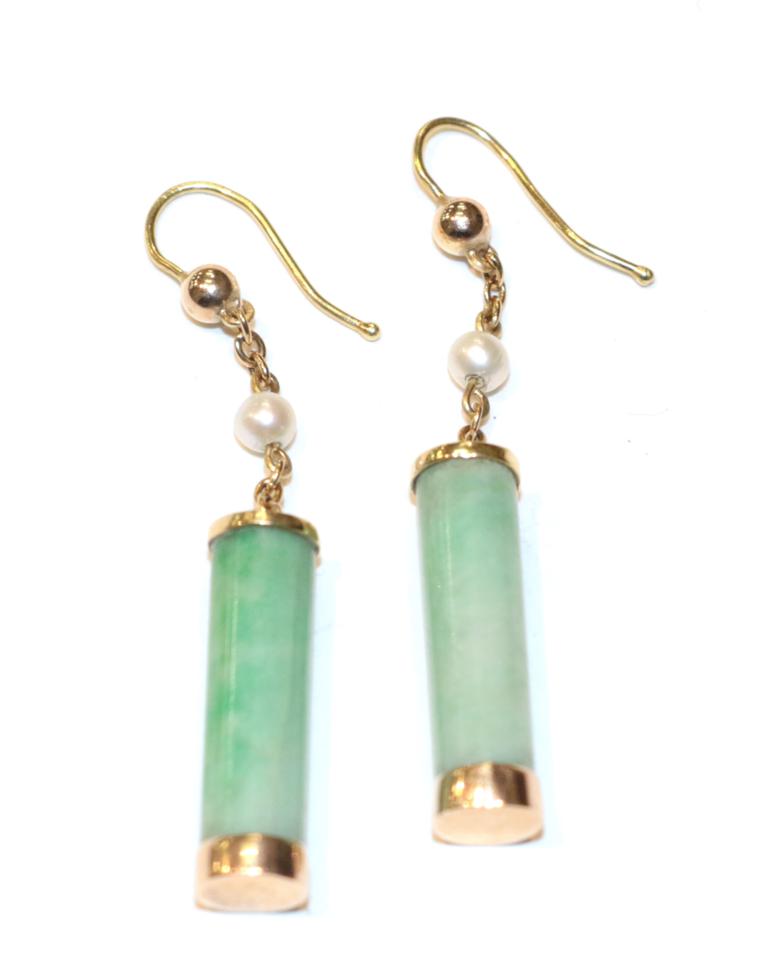 Lot 271 - A pair of jade and cultured pearl drop earrings, jade barrels in yellow rubbed over settings...