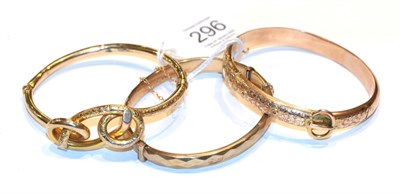 Lot 296 - A foliate and buckle motif hinged bangle, stamped '9' and '.375'; a 9 carat gold hinged bangle; and