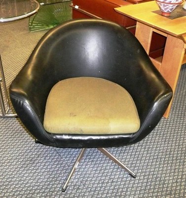 Lot 1561 - A 1960's Black Vinyl Swivel Chair, with shaped back, on a chrome base with black feet,...