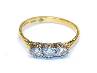 Lot 310 - An 18 carat gold diamond three stone ring, finger size P