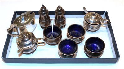 Lot 335 - An eight-piece George V silver condiment-set, by Adie Brothers, Birmingham, 1927, one...