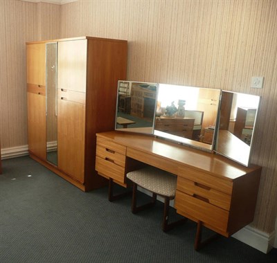 Lot 1562 - A 1965 Uniflex Teak Bedroom Suite, comprising 5' fitted wardrobe, 3' fitted wardrobe, kneehole...