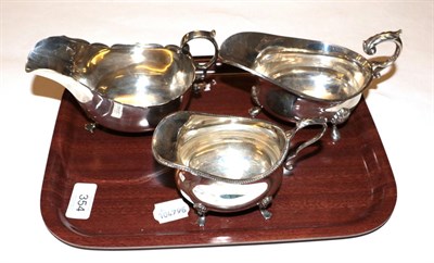 Lot 354 - A silver cream-jug and two various silver sauce-boats, the first by William Hutton and Sons,...