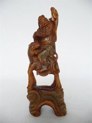 Lot 173A - A Chinese Carved and Stained Bovine Horn Figure of a Mythical Warlord Riding a Fo Dog, late...