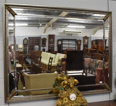 Lot 400 - A reproduction bevelled glass sectional mirror with silvered frame, 115cm by 146cm