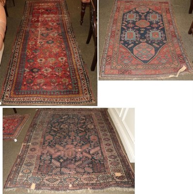 Lot 422 - A Kashgai rug, the indigo field of tribal motifs enclosed by ivory borders, 220cm by 172cm;...