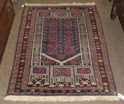 Lot 425 - A Baluch prayer rug, the field with two columns of hooked guls beneath the Mihrab enclosed by...