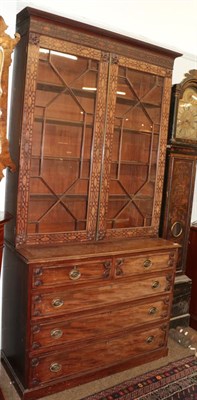 Lot 467 - A 19th century mahogany bookcase, the glazed upper section decorated with blind fret-work over...