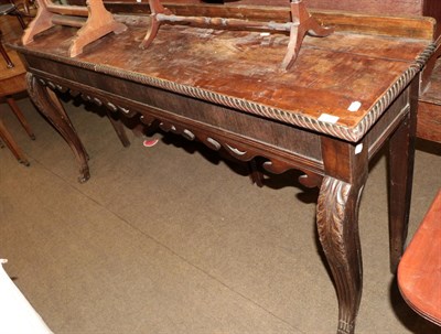 Lot 495 - A George III style mahogany serving table with gadrooned border and carved apron, raised on...