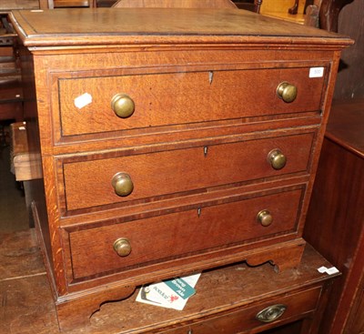 Lot 500 - An oak and mahogany crossbanded chest with hinged top, modelled as a chest of drawers