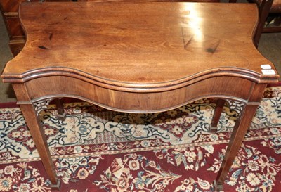 Lot 513 - An early 19th century Chippendale style serpentine fronted mahogany fold over tea table, with...