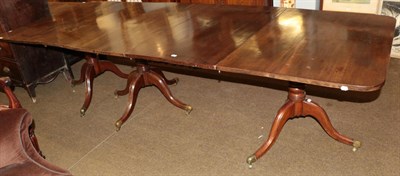 Lot 518 - A 19th century mahogany triple pillar dining table, 295cm fully extended