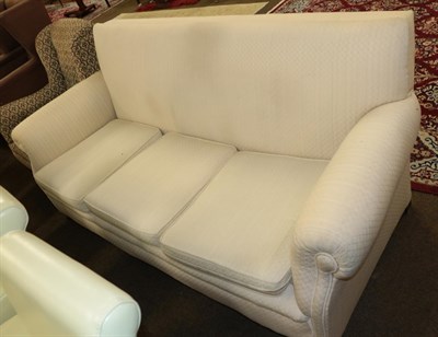 Lot 523 - An early 20th century three-seater sofa recovered in cream fabric, 203cm wide