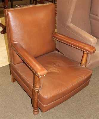 Lot 525 - An early 20th century brown leather open armchair