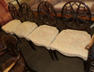 Lot 538 - A set of four 19th century dining chairs with circular backs, designed with radiating acanthus...