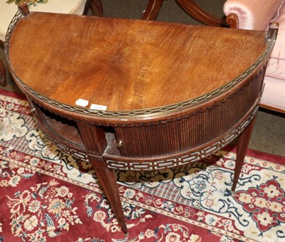 Lot 541 - A mid 19th century mahogany demi lune side table with raised brass gallery, tambour fronted drawers