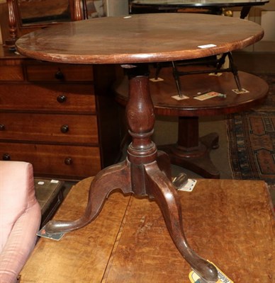 Lot 544 - A George III mahogany tilt top tripod table raised on pad feet