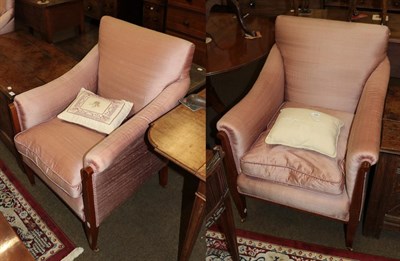 Lot 546 - A pair of Edwardian mahogany and satinwood strung armchairs with pink silk upholstery, raised...