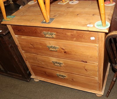 Lot 562 - An early 20th century stripped pine chest of drawers, with an arrangement of four graduated...