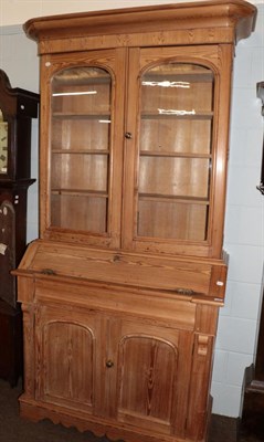 Lot 580 - An late 19th/early 20th century pine bureau bookcase with shaped apron; and a four leaf printed...