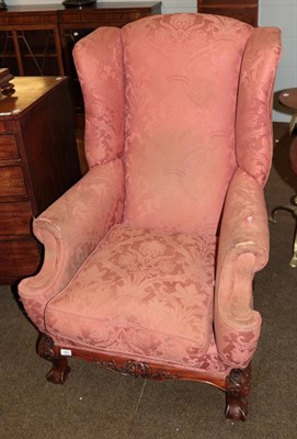 Lot 589 - A 1920s wing back armchair