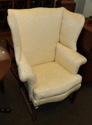 Lot 592 - A 19th century wing back chair on square fluted legs, 77cm wide