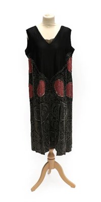 Lot 2053 - A 1920's Black Silk Flapper Dress, with pink silk appliqué roundels, a skirt of panelled...